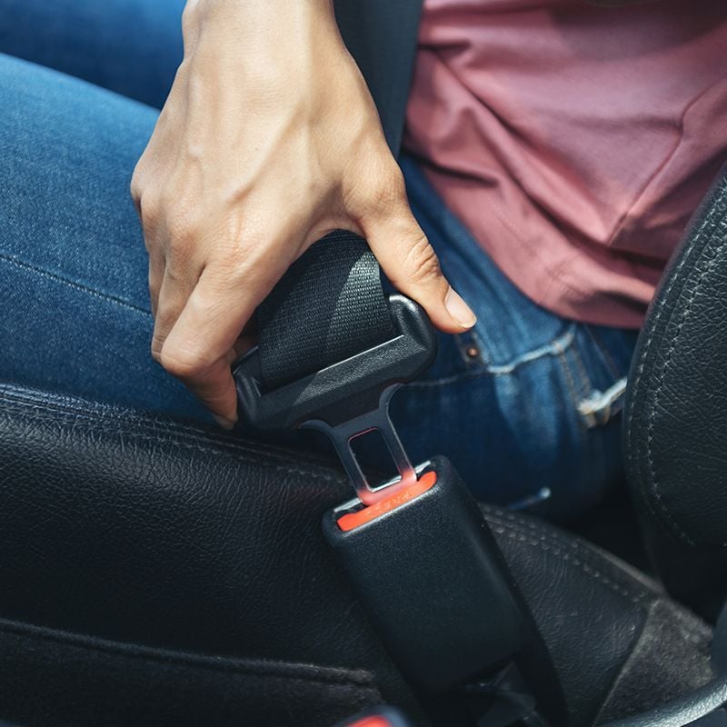 woman-hand-fastening-seatbelt-car-cropped-image-woman-sitting-car-putting-her-seat-belt-safe-driving-concept.jpg